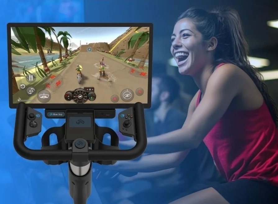 A rider laughing mid-game on a Blue Goji bike running GojiPlay