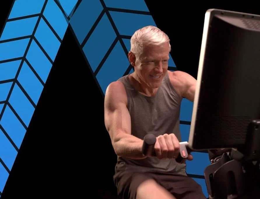 An older adult training on Blue Goji interactive cardio