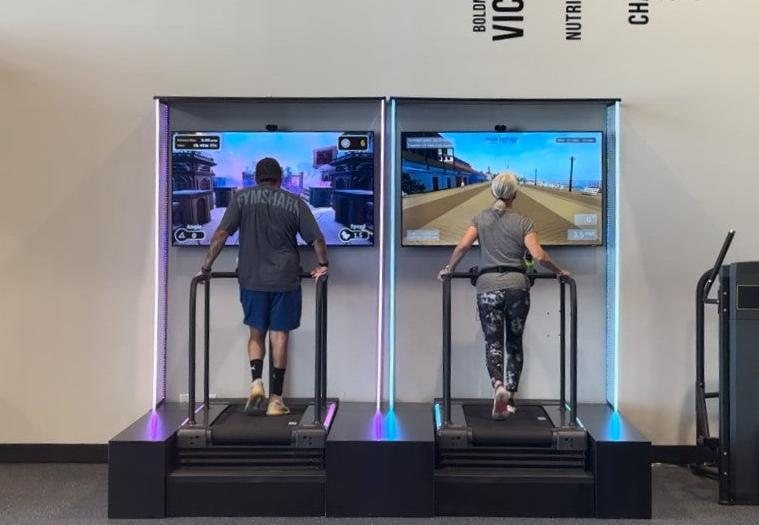 Two members dual-tasking on Xpriential interactive treadmills